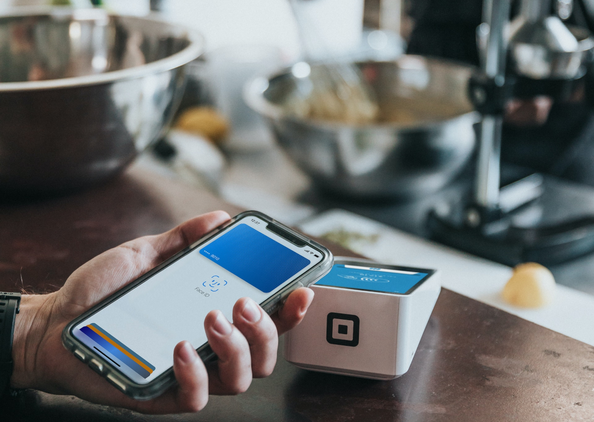 Someone tapping their card to make a digital payment.