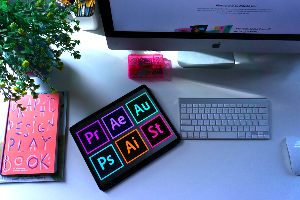 Adobe graphic design apps on a table