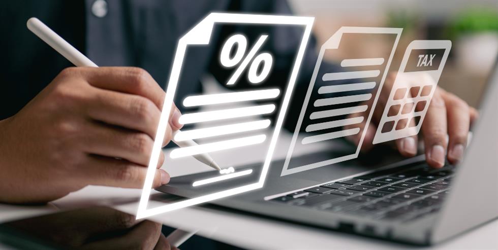 Business owner working out taxes on a laptop