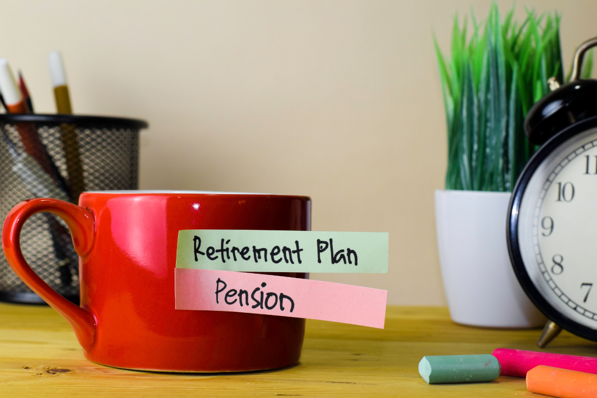 A tea cup that has 'retirement plans' and 'pension' written on it.